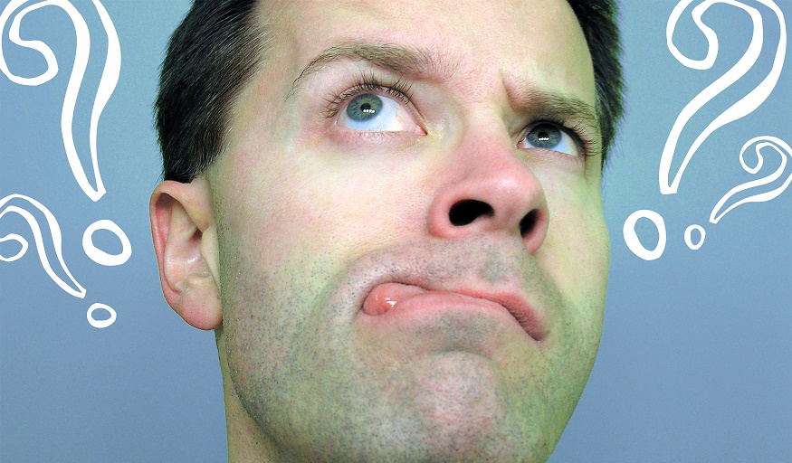 Man with questioning face surrounded by question marks